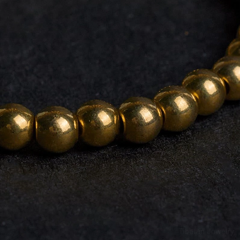 Close-up of uniform polished copper brass beads showing consistent metallic finish and craftsmanship