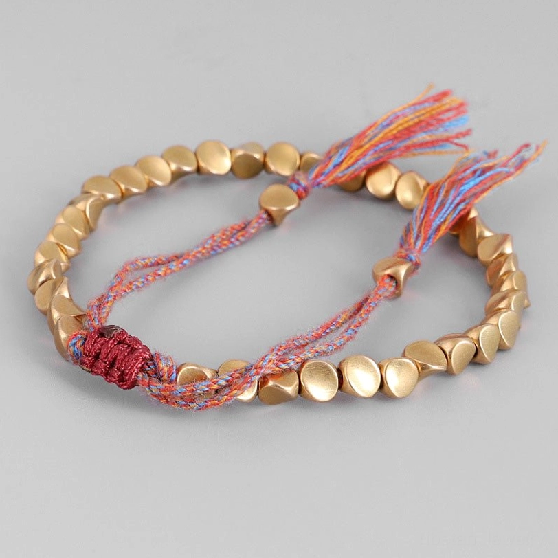 Colorful tassel copper healing bracelet with matte gold beads and mixed red-blue-orange woven rope