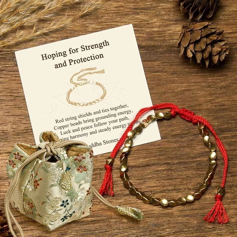 Deluxe embroidered silk drawstring gift bag with copper beads bracelet on wooden desktop with pinecones and natural dried elements