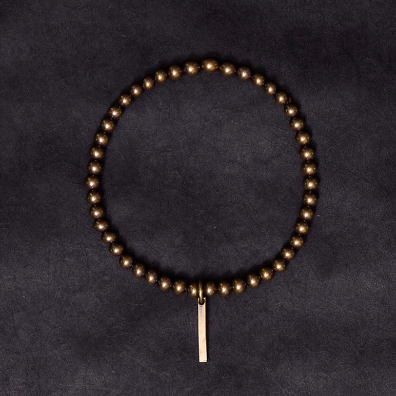 Full circle copper healing bracelet overhead view with decorative long bar pendant