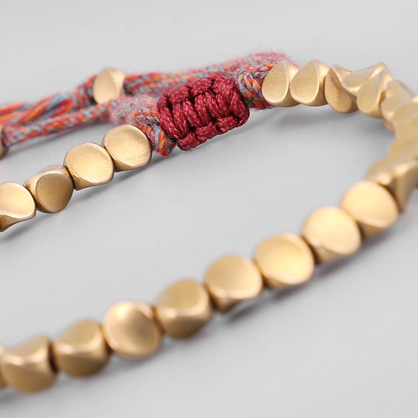 Tibetan copper healing bracelet detail shot showing authentic handmade copper beads and traditional knot construction