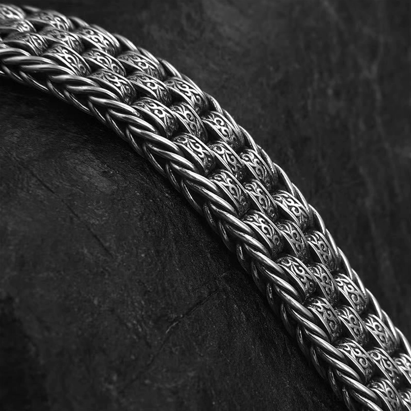 Macro close-up of the Om Mani Padme Hum copper bracelet showing the intricate twisted braided texture and vintage oxidized copper finish