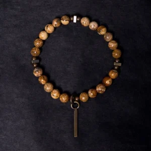 Tibetan stone beaded bracelet overhead view, copper metal spacers and vertical bar charm detail
