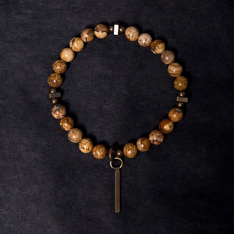 Tibetan stone beaded bracelet overhead view, copper metal spacers and vertical bar charm detail