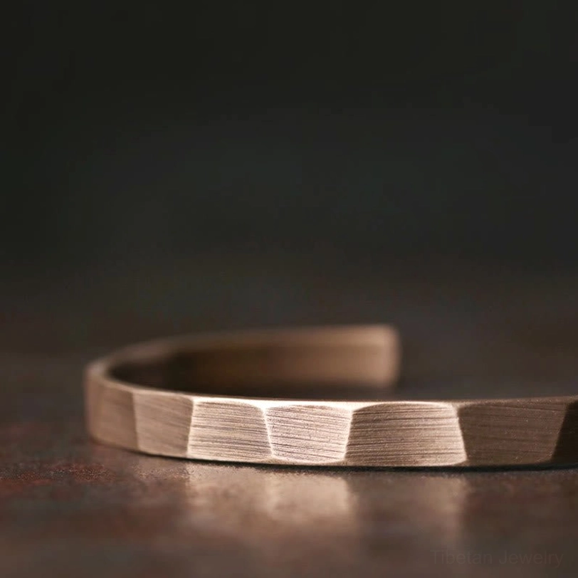 Copper wealth cuff bracelet low side profile showing horizontal brushed facet texture and open adjustable design