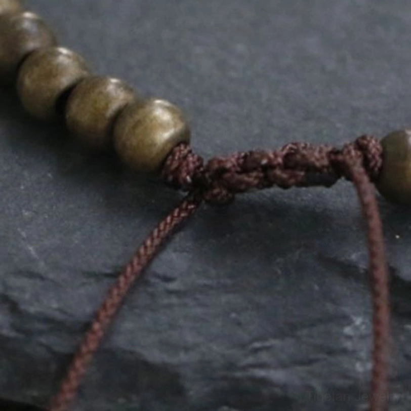 Copper brass beads bracelet with handwoven brown cord featuring adjustable knot mechanism for universal fit