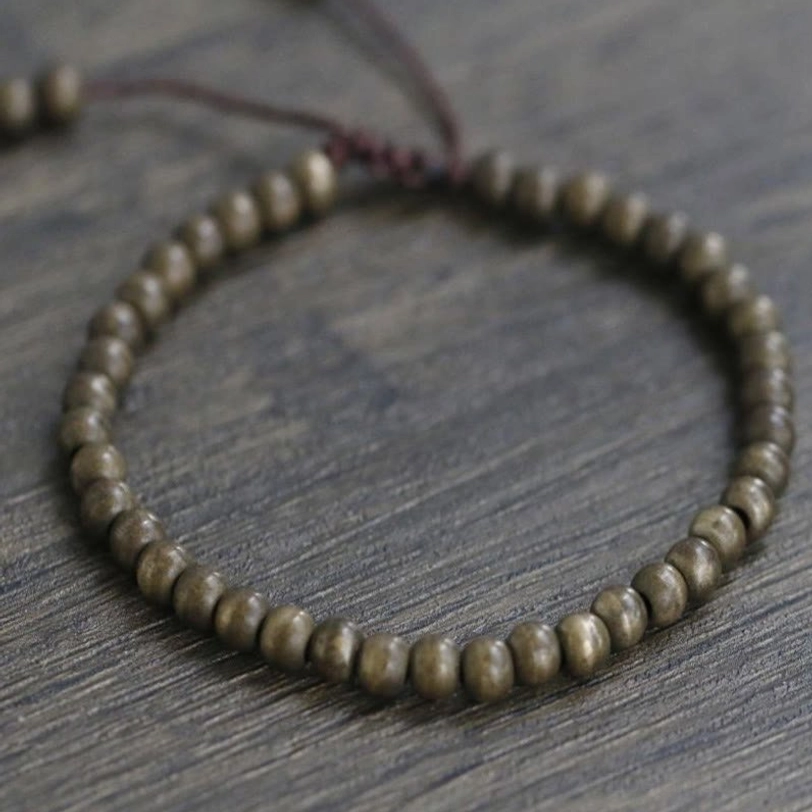 Lifestyle photograph of copper brass beads bracelet emphasizing minimalist design suitable for daily wear and meditation practice