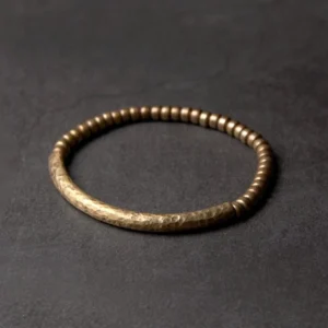 Handcrafted copper brass beaded bracelet with small 5mm beads in hammered vintage bronze finish, overhead flat lay view