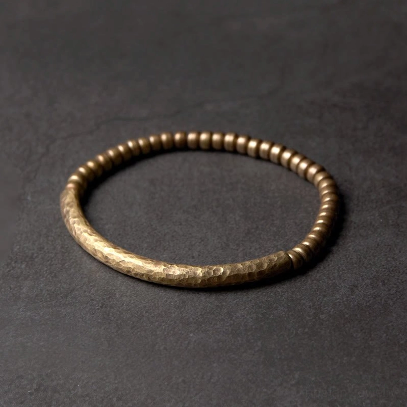 Handcrafted copper brass beaded bracelet with small 5mm beads in hammered vintage bronze finish, overhead flat lay view