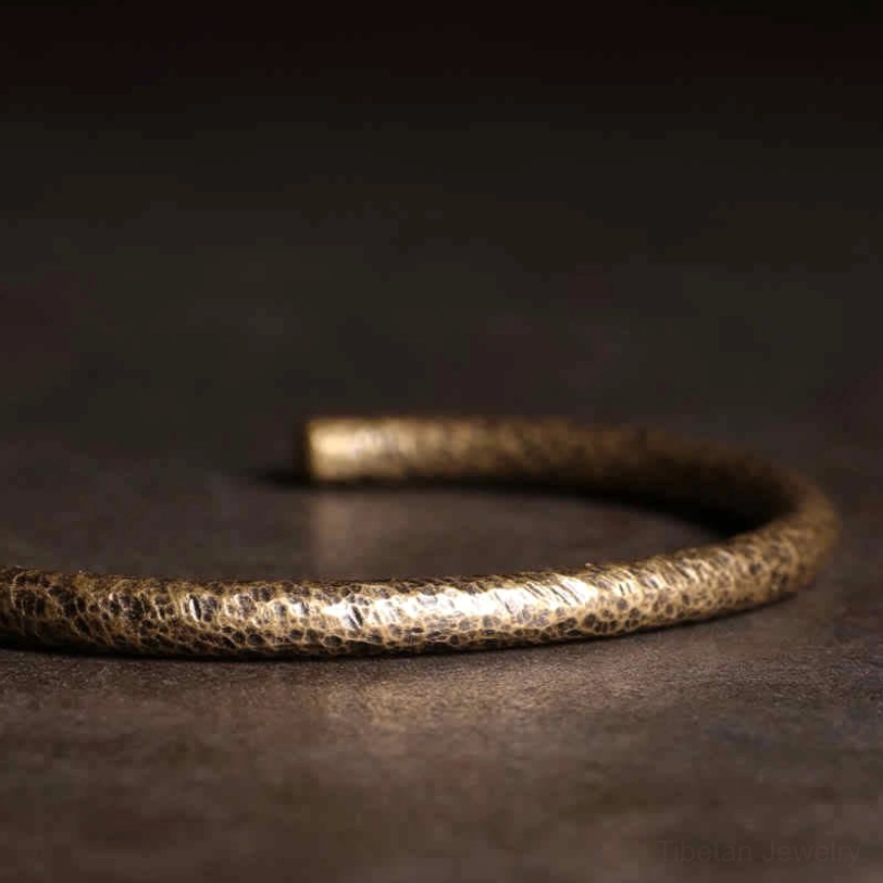 Copper cuff bracelet detail shot showcasing hammered texture and open-ended adjustable design