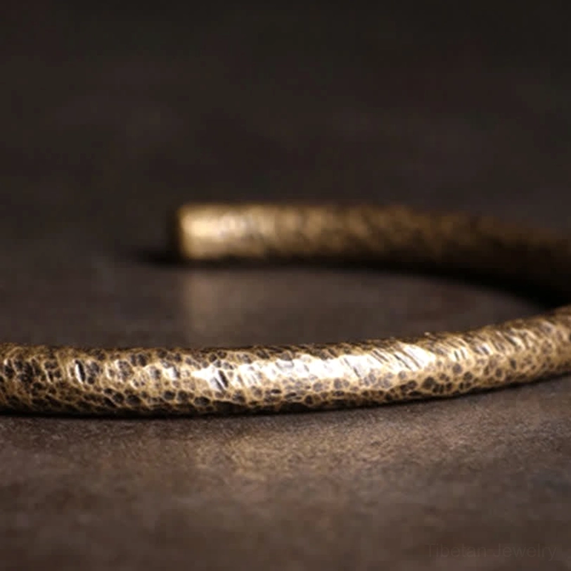 Layered copper cuff bracelets stacked together, demonstrating versatile styling options