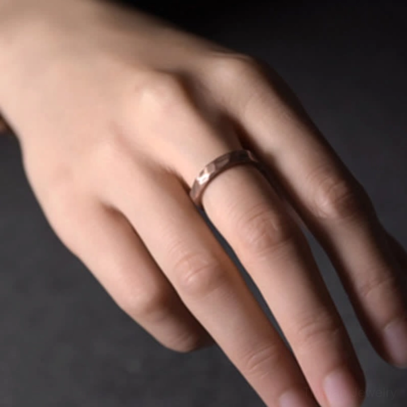 Adjustable copper ring worn on middle finger close-up side view fit