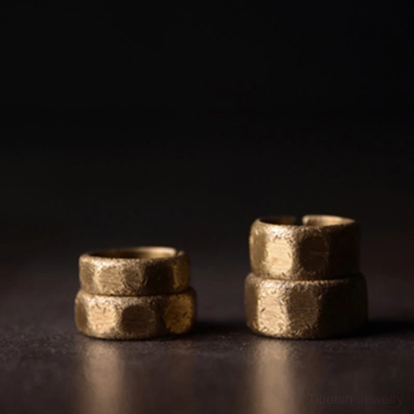 Matching pair of frosted copper prosperity rings - front flat lay showing two available sizes with hammered texture