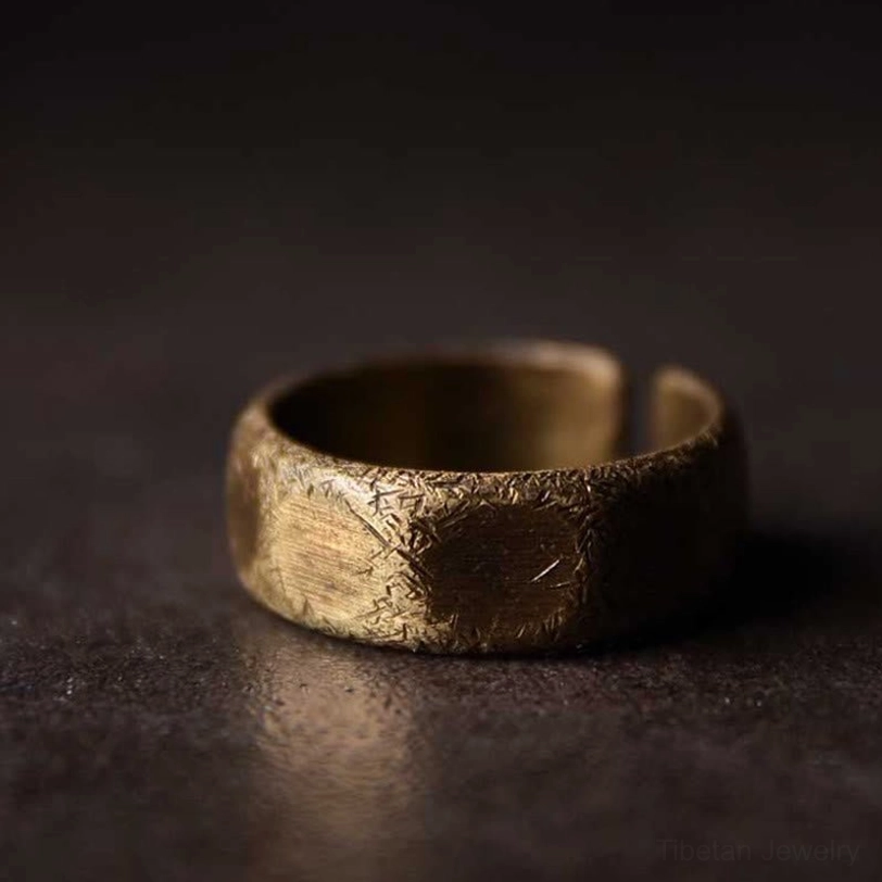 Close-up top-side view of frosted copper ring - detailed hammered scratch texture and full front band design