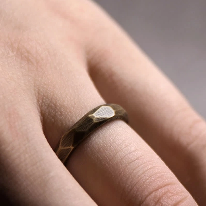 Polished bronze copper ring front close-up geometric facets clear detail