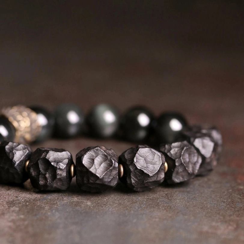 Mixed bead bracelet detail showing copper spacers smooth obsidian and rough stone beads texture