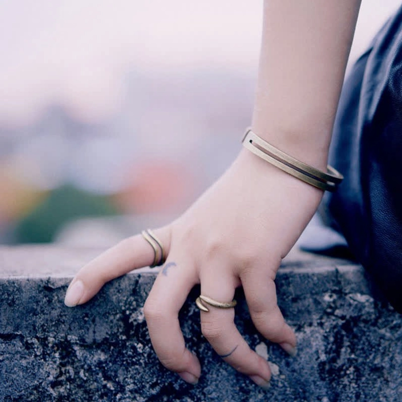 Viking copper cuff bracelet worn on hand with matching rings, lifestyle wrist photo showing stacked jewelry style