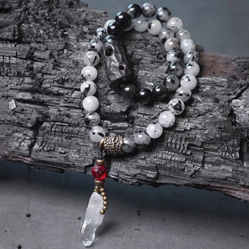 Couple beaded bracelet with black rutilated quartz clear crystal drop pendant flat lay
