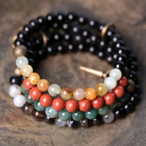 Stacked matching couple bracelet set with mixed natural stones and copper hardware on wooden table - pair of healing crystal bracelets