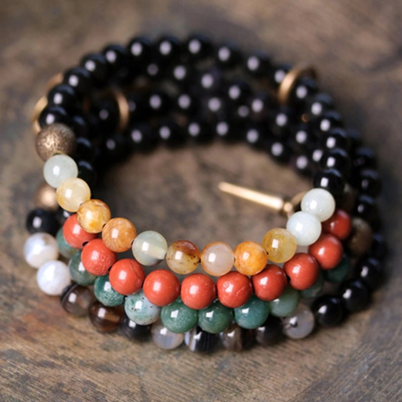 Stacked matching couple bracelet set with mixed natural stones and copper hardware on wooden table - pair of healing crystal bracelets