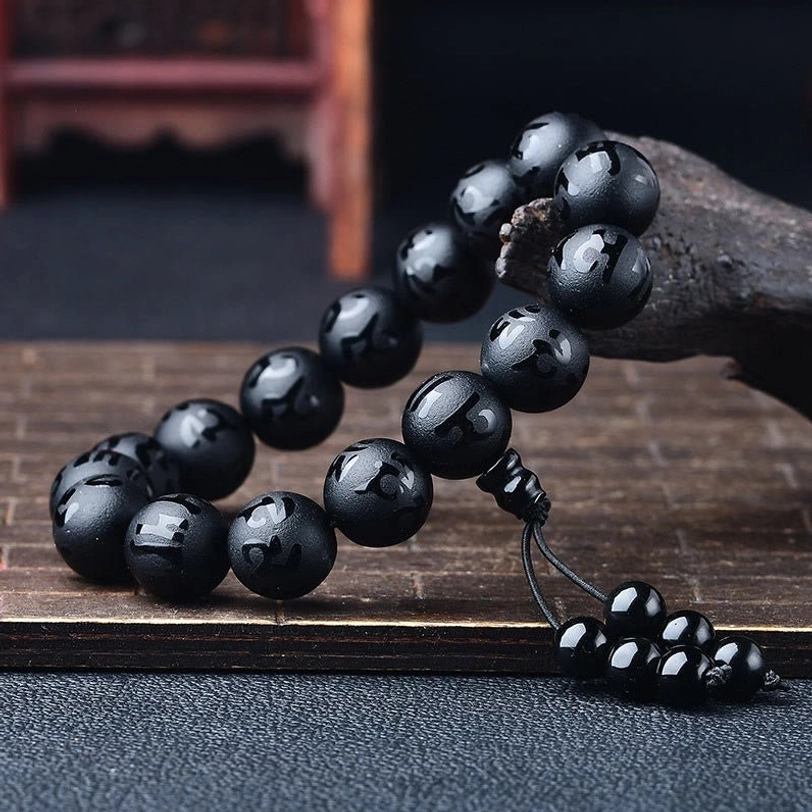 White crystal and black onyx meditation bracelet stack showing size variations