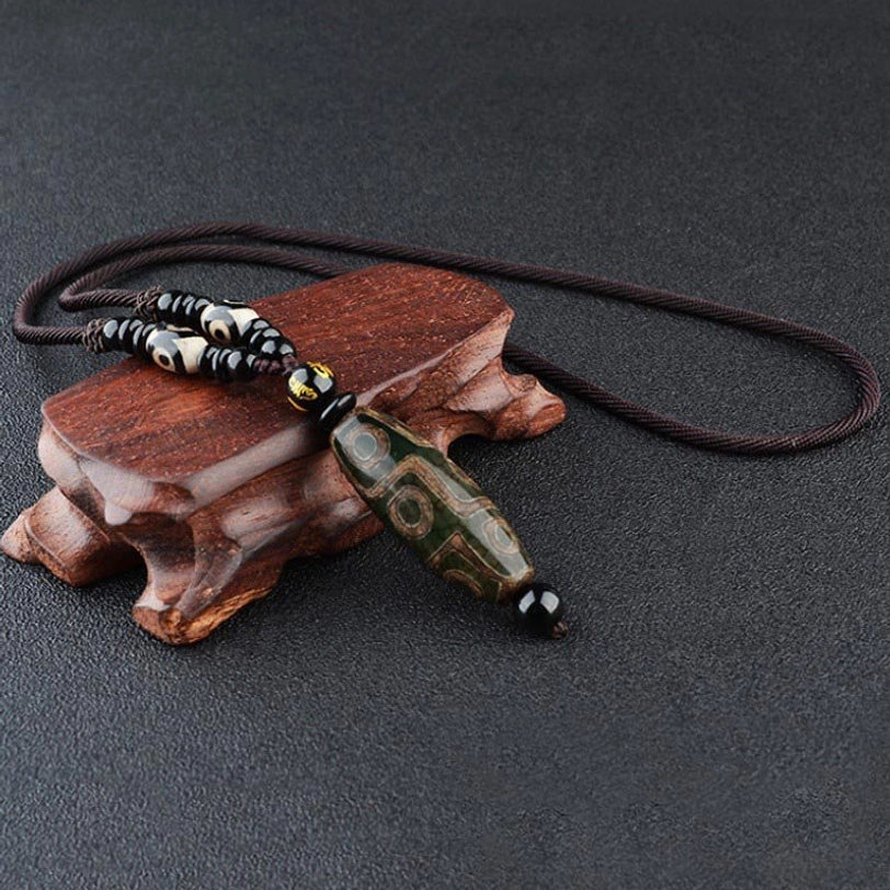 Dark green nine-eye Dzi bead necklace with textured agate and black cord accents, handcrafted Tibetan protection amulet pendant