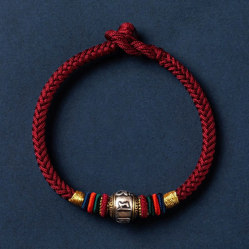 Single dark red Tibetan Om Mani Padme Hum protection bracelet with silver charm and woven knot closure
