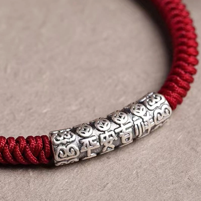 Dark red Tibetan rope bracelet with adjustable knot closure, handmade sterling silver charm with mantra engraving