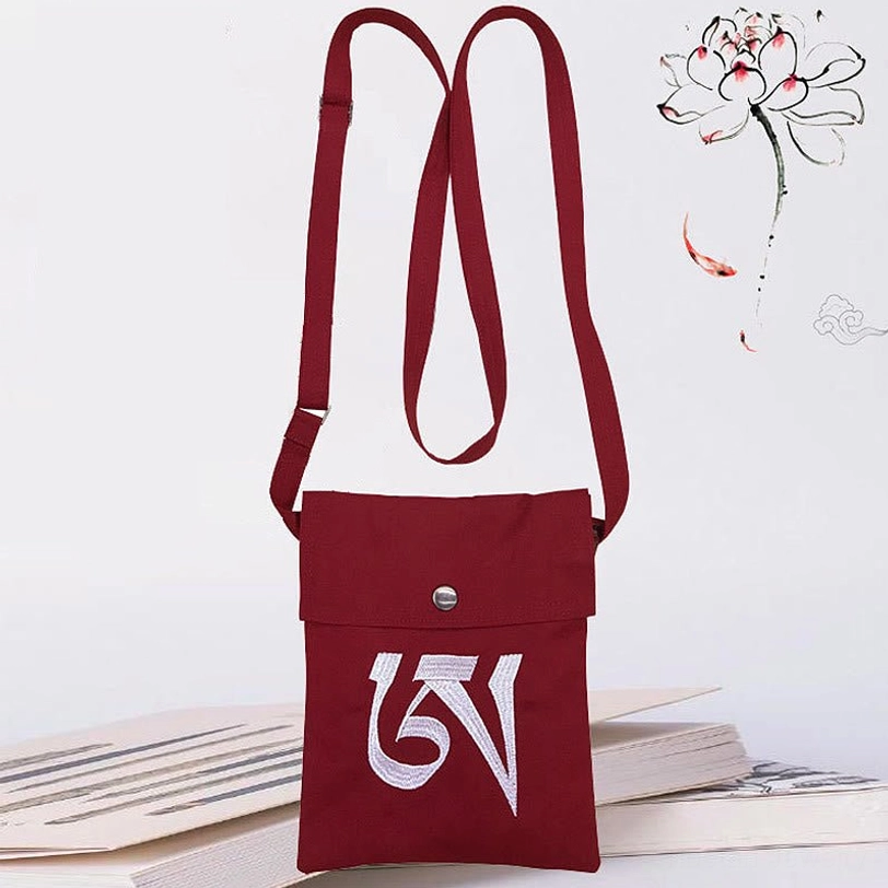 Dark red burgundy Tibetan OM mantra crossbody bag with white embroidered detailing, adjustable canvas strap, snap closure