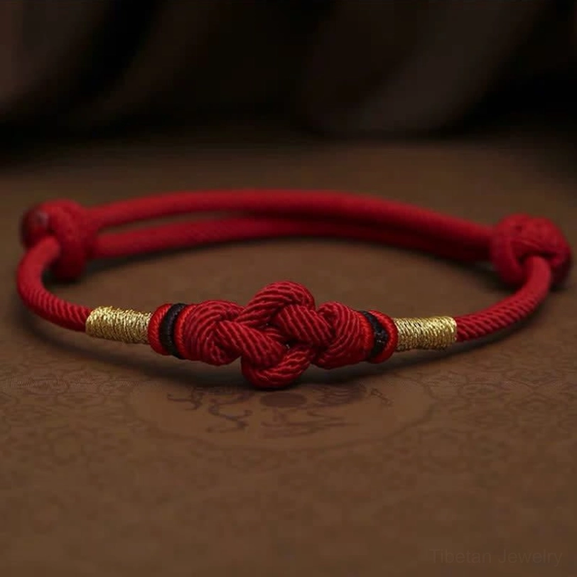 Dark red Tibetan string bracelet variant with jade beads and adjustable knot closure