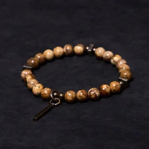 Distressed copper luck bracelet with natural stone beads, flat lay top view showing antique copper pendant charm