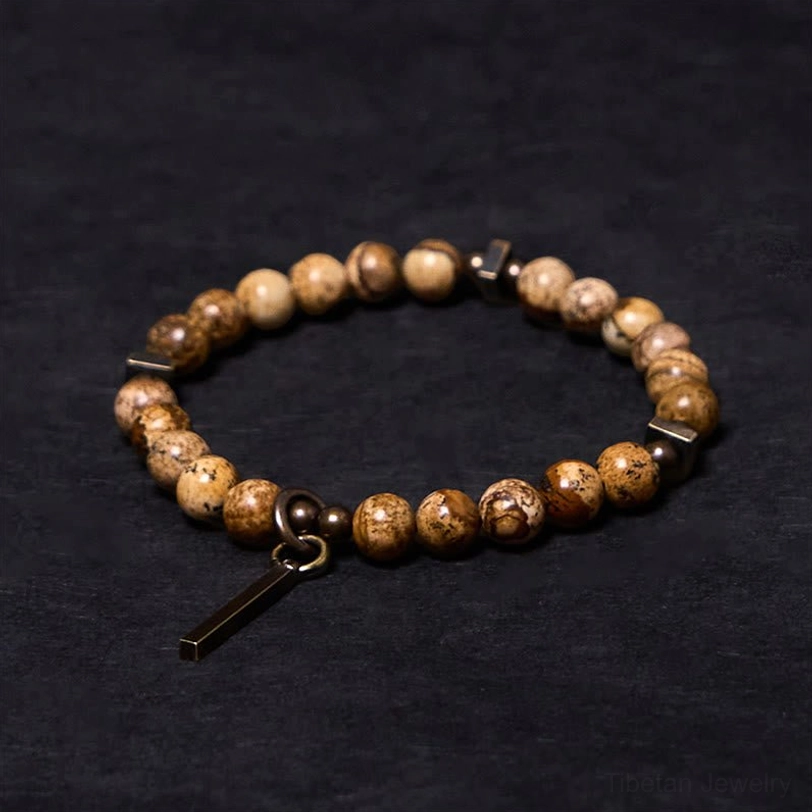 Distressed copper luck bracelet with natural stone beads, flat lay top view showing antique copper pendant charm
