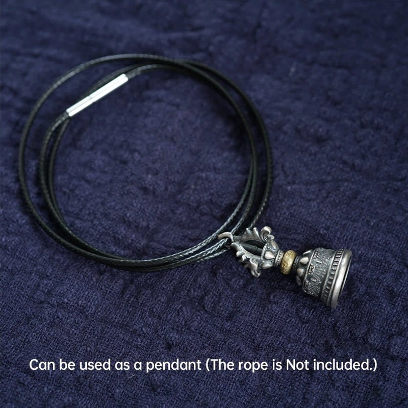 Tibetan dorje bell necklace pendant set on dark blue fabric, displayed flat without wax cord (cord not included)