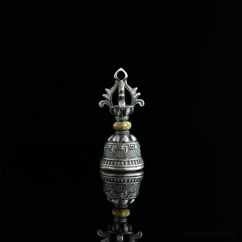 Upright dorje bell ornament with embossed Buddhist patterns and rotatable brass components, pure black background