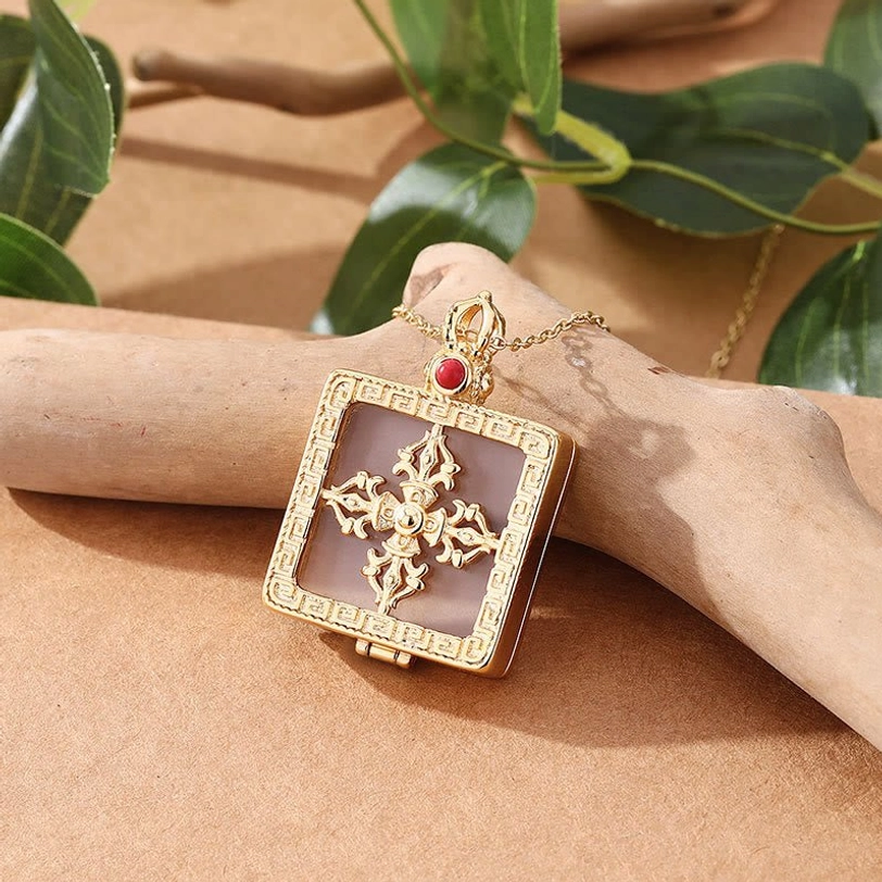 Hinged double dorje jade locket pendant with translucent white jade inlay and open gold case design