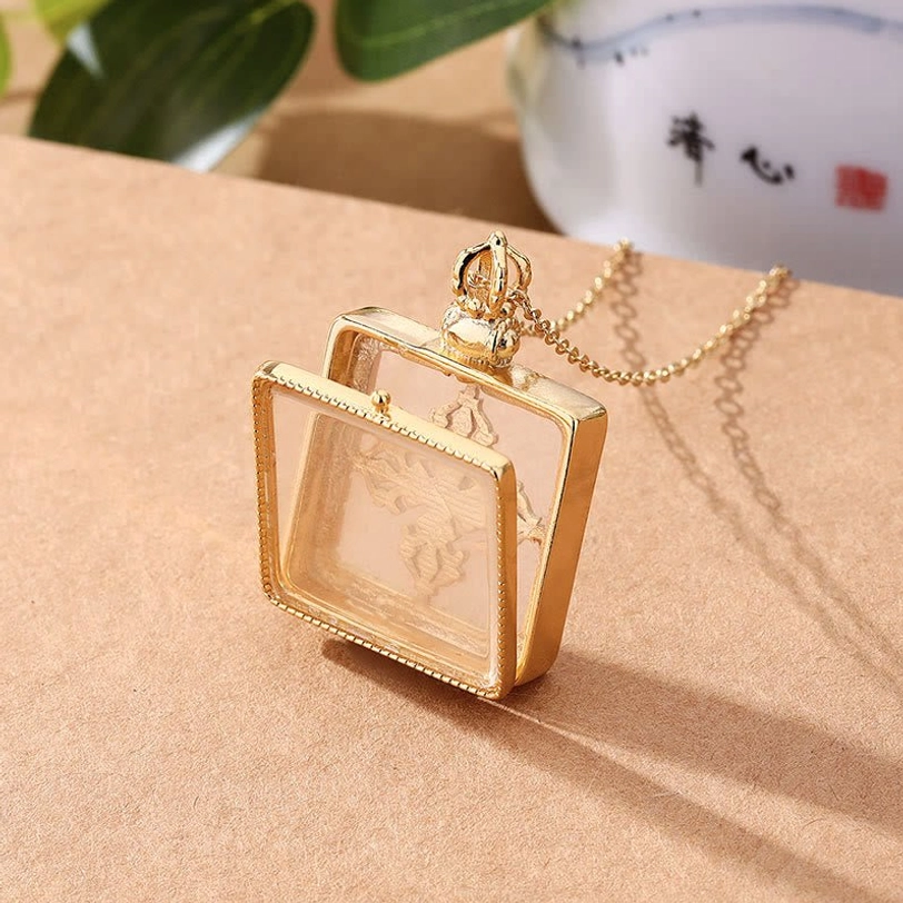 Tibetan dorje pendant locket with empty interior compartment and attached gold chain back view