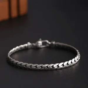 Close-up detail of double dorje vajra symbol and copper chain links with premium buckle closure