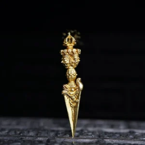 Dorje Vajra ornament frontal view on carved dark base, gold-toned finish with multi-dimensional deity carving details and spiritual engravings
