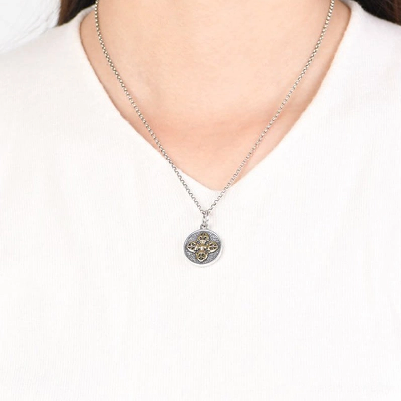 Woman wearing tibetan double dorje vajra necklace on white clothing showing dainty wearable style