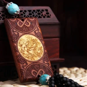 Front view of wooden dragon car ornament featuring brown rosewood body with turquoise bead accents and intricate carving details