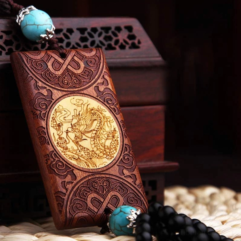 Front view of wooden dragon car ornament featuring brown rosewood body with turquoise bead accents and intricate carving details