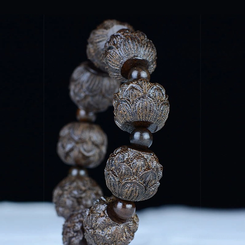 Dragon carved ebony wood bracelet with mythical dragon engraved beads showing celestial protection symbolism