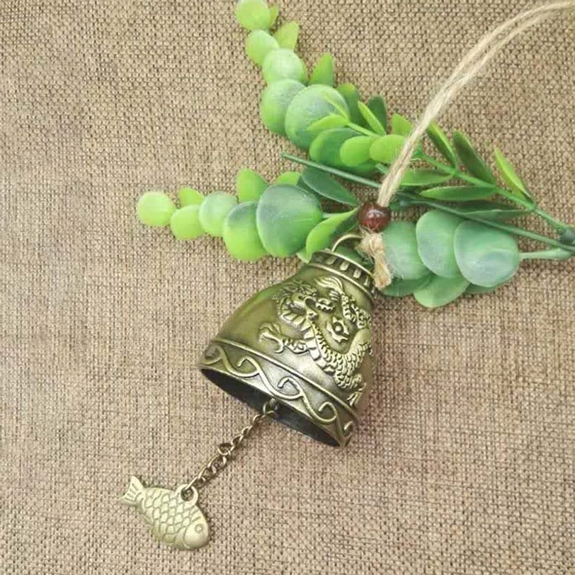 Dragon carved antique bronze Tibetan wind chime bell with embossed dragon design and traditional fish pendant