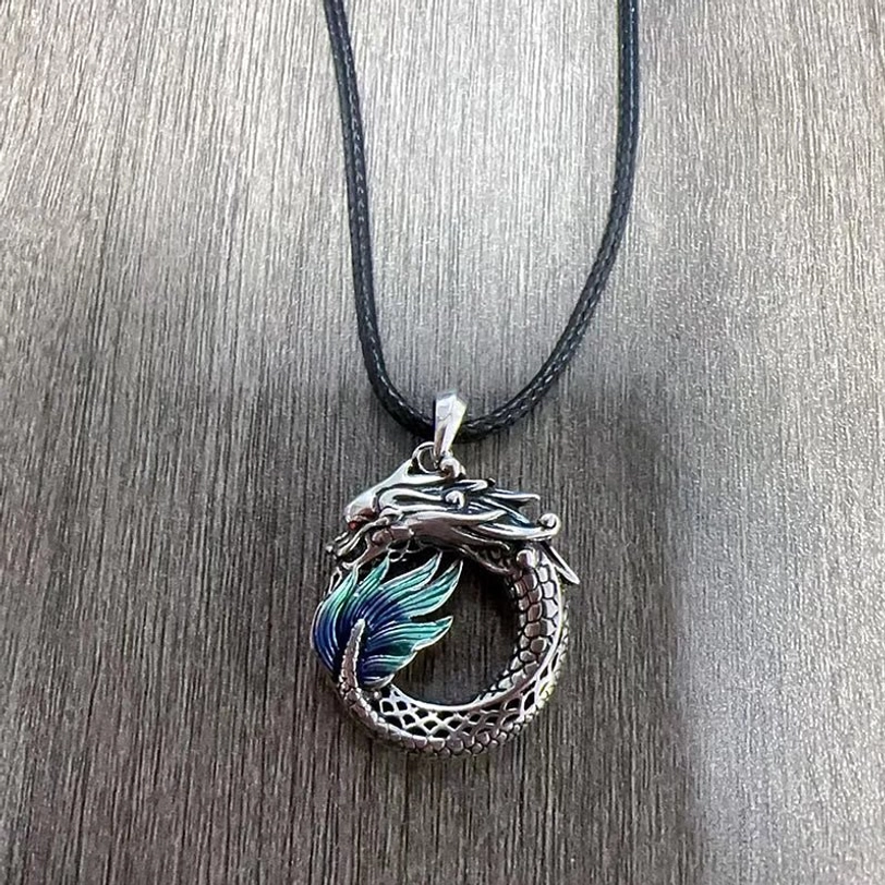 Dragon necklace with genuine leather cord - traditional Tibetan style on wood background