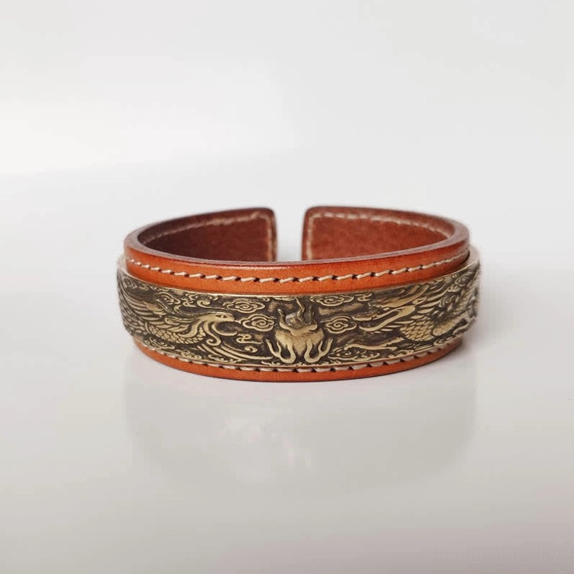 Tibetan leather cuff bracelet with carved dragon and phoenix pattern in antique bronze