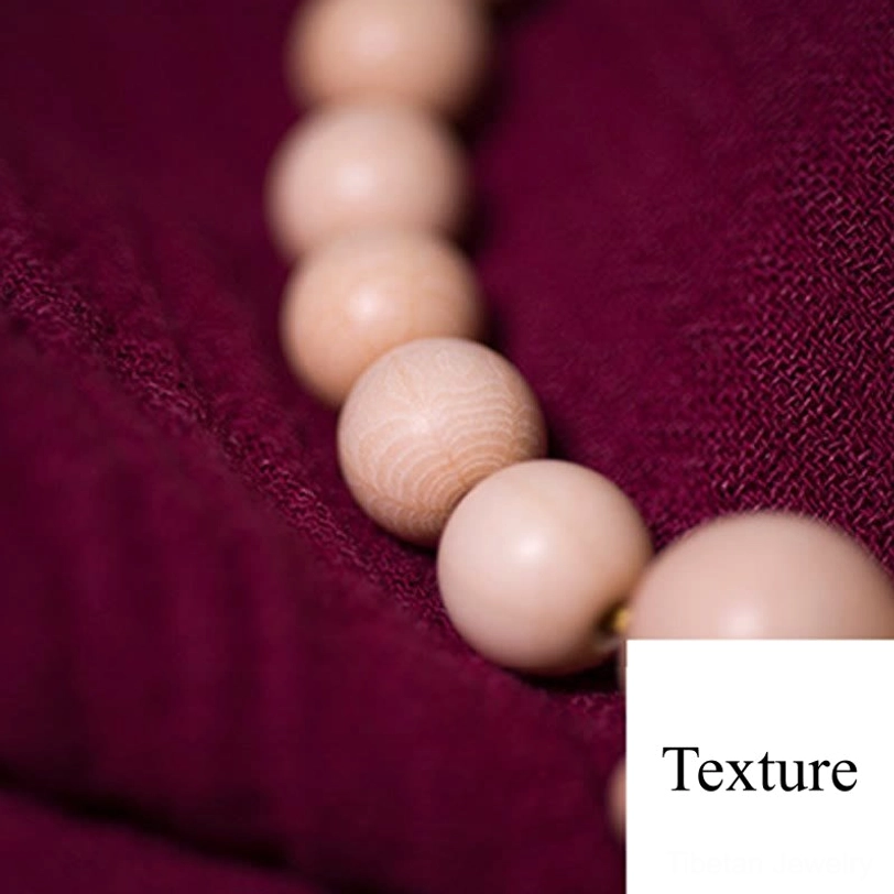 Detailed side view of Abelia Biflora wooden mala beads displaying visible natural wood grain patterns and matte cream finish characteristic of Dragon Wood