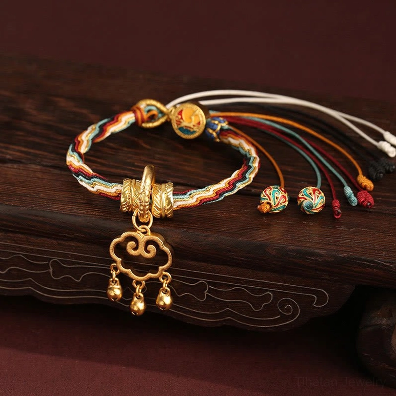 Dunhuang color braided lucky bracelet with cloud lock pendant and enamel charm beads on carved wooden board
