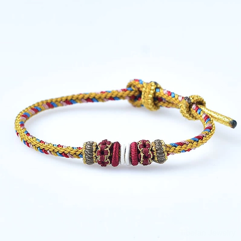 Handmade Dunhuang Tibetan bracelet detail shot of braided cord and decorative elements