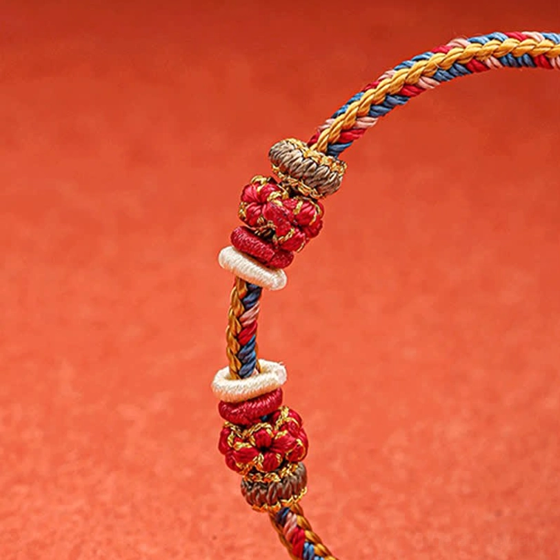 Handmade Dunhuang bracelet side view showing twisted braid texture and decorative knot details