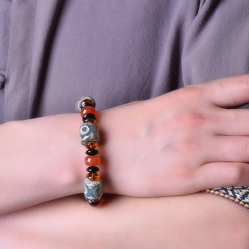 Tibetan Dzi Bead Agate Bracelet worn on wrist - on-model close-up showing how the protection bracelet fits and looks when worn, demonstrating comfortable elastic fit